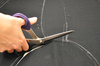 cutting fabric - photo/picture definition - cutting fabric word and phrase image