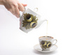 pouring tea - photo/picture definition - pouring tea word and phrase image